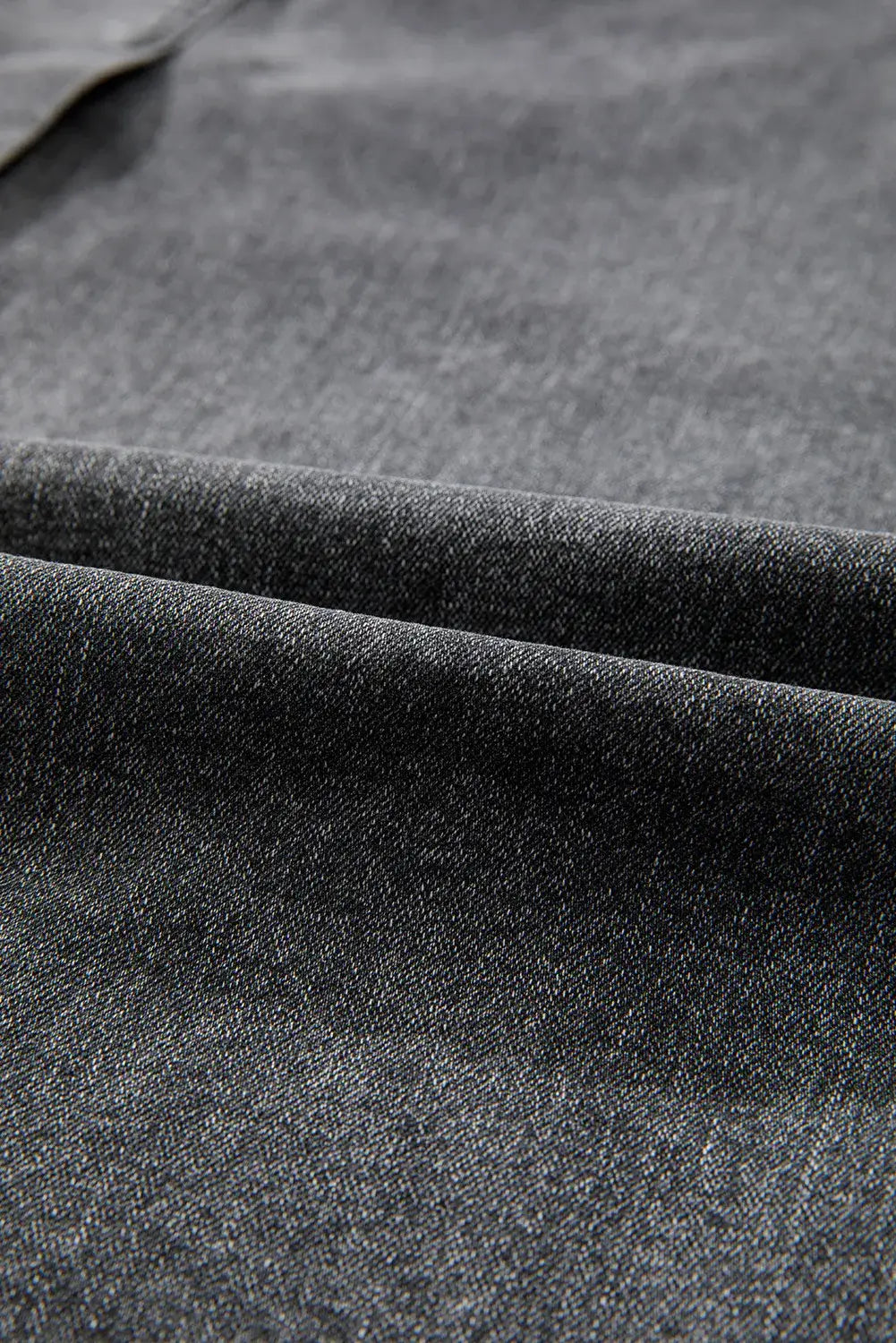 Close-up of Bella Road Raw Hem Midi Denim Skirt fabric showing soft, textured high-quality denim in dark wash.