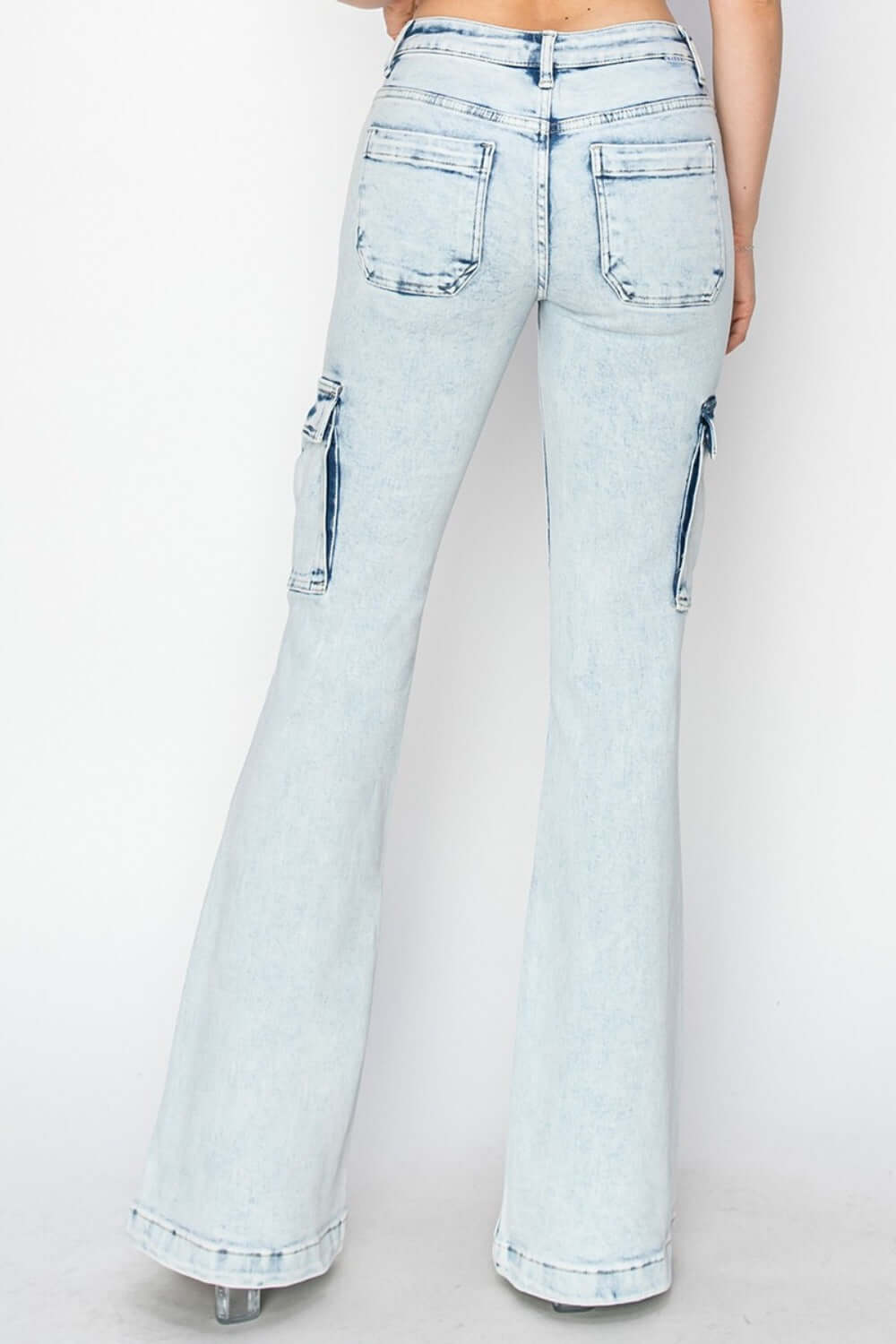 High rise denim flared jeans with back pockets and side cargo details, showcasing a stylish and comfortable retro design.