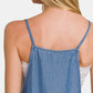 Back view of a woman wearing washed denim overalls with adjustable straps, showcasing a relaxed style and casual look.