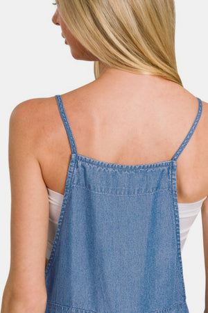 Back view of a woman wearing washed denim overalls with adjustable straps, showcasing a relaxed style and casual look.