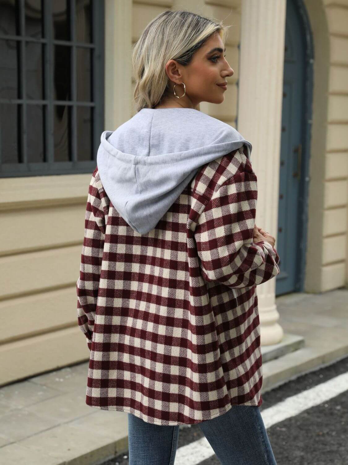 Woman wearing Bella Road Drawstring Plaid Long Sleeve Hooded Jacket in outdoor setting