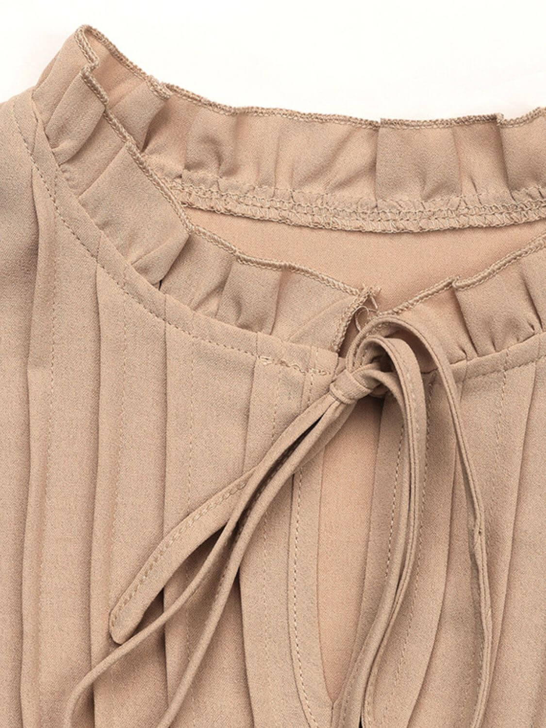 Close-up of Perfee Frill Tie Neck Long Sleeve Blouse showcasing tie neck and ruffled details.