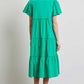 Woman wearing HEYSON green cotton poplin ruffled tiered midi dress, showcasing back view and elegant flowy design.