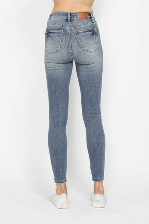 Judy Blue full size tummy control contrast wash skinny jeans back view showcasing sleek design and flattering fit.