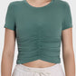 Stylish dark green ruched short sleeve active t-shirt, perfect for workouts or casual wear.