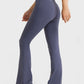 Model showcasing Millennia Elastic Waist Flare Yoga Pants in navy, ideal for yoga and stylish workouts.