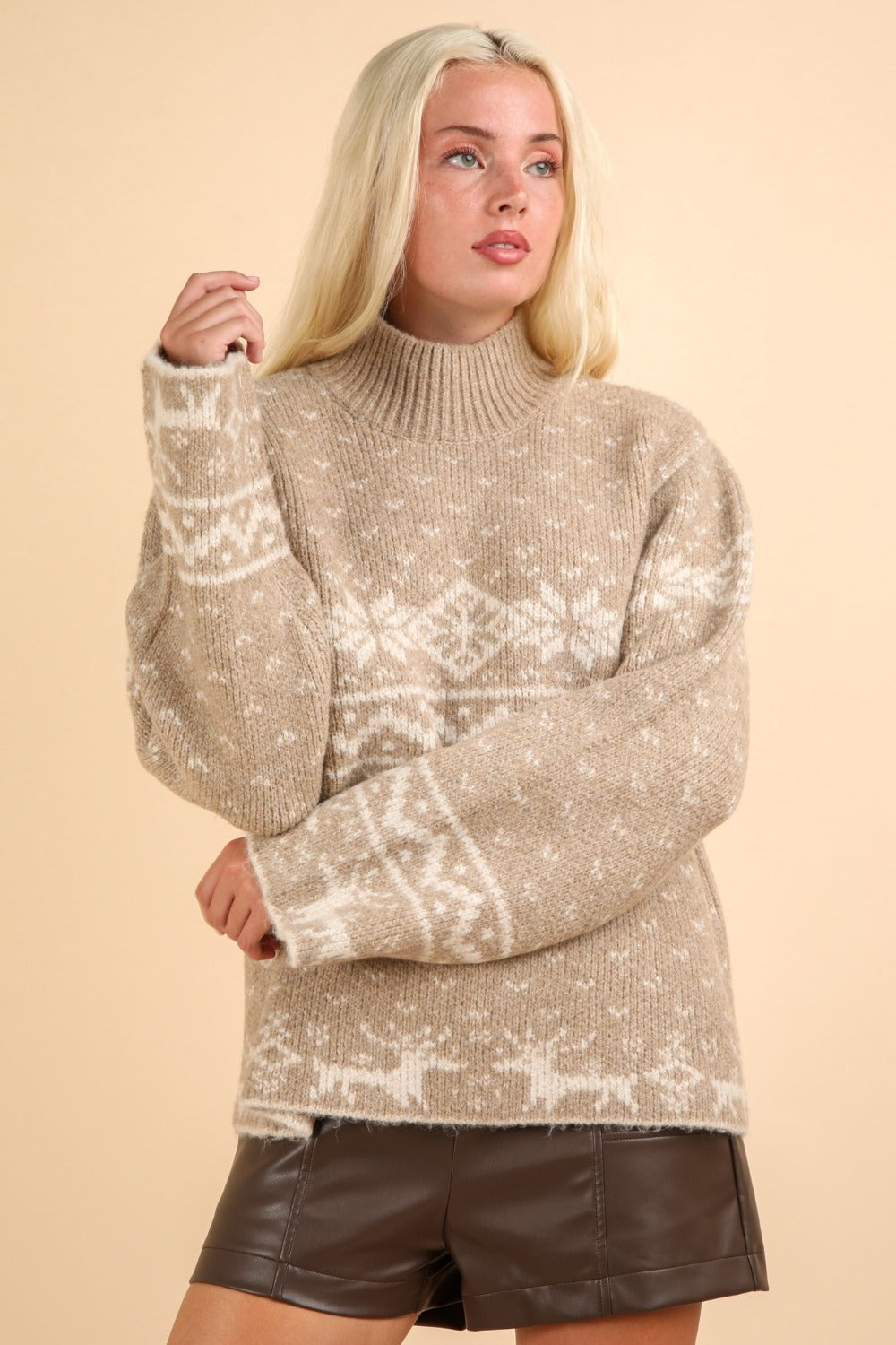 Cozy mock neck sweater with festive reindeer and snowflake patterns, perfect for winter warmth and holiday style.