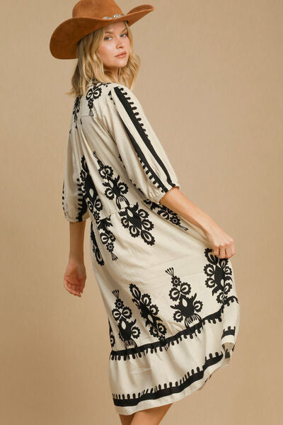 Umgee Printed Notched Midi Dress with black print, stylish notched neckline, and chic cowboy hat for a trendy look.