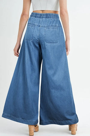 Woman wearing drawstring elastic waist wide leg jeans made of 100% cotton, showing back view and high-waisted design.