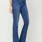 High Waist Bootcut Jeans in blue denim worn with a casual grey top and white heels.