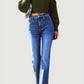 Woman wearing Bella Road Straight Leg Jeans with spacious pockets, paired with a green knitted sweater.