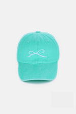 Mint green cotton cap with delicate bow embroidery, offering a stylish and comfortable fit.