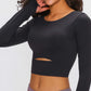 Black long sleeve cropped top with sports strap and cutout detail, perfect for stylish support and comfort during workouts.