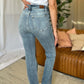 Woman wearing Judy Blue full size medium rise bootcut jeans in a living room setting, showcasing back view and flattering fit.