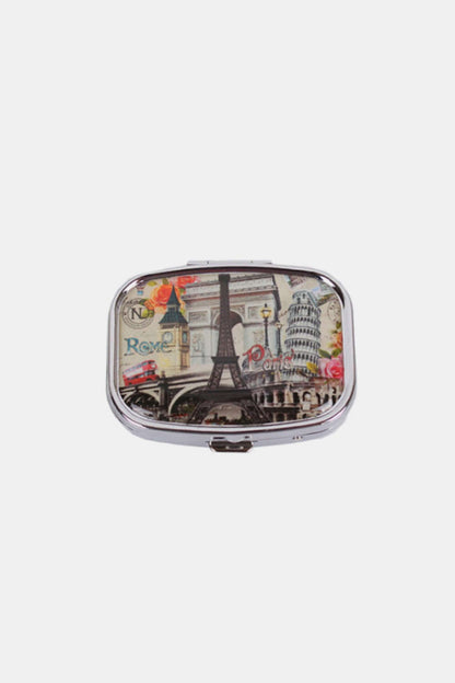 Nicole Lee USA Print Metallic Rectangular Pill Case with travel-themed design, silver-tone metal exterior, compact size for portability.