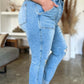 Woman modeling Judy Blue distressed straight jeans with patch pockets, showcasing a stylish and flattering silhouette.