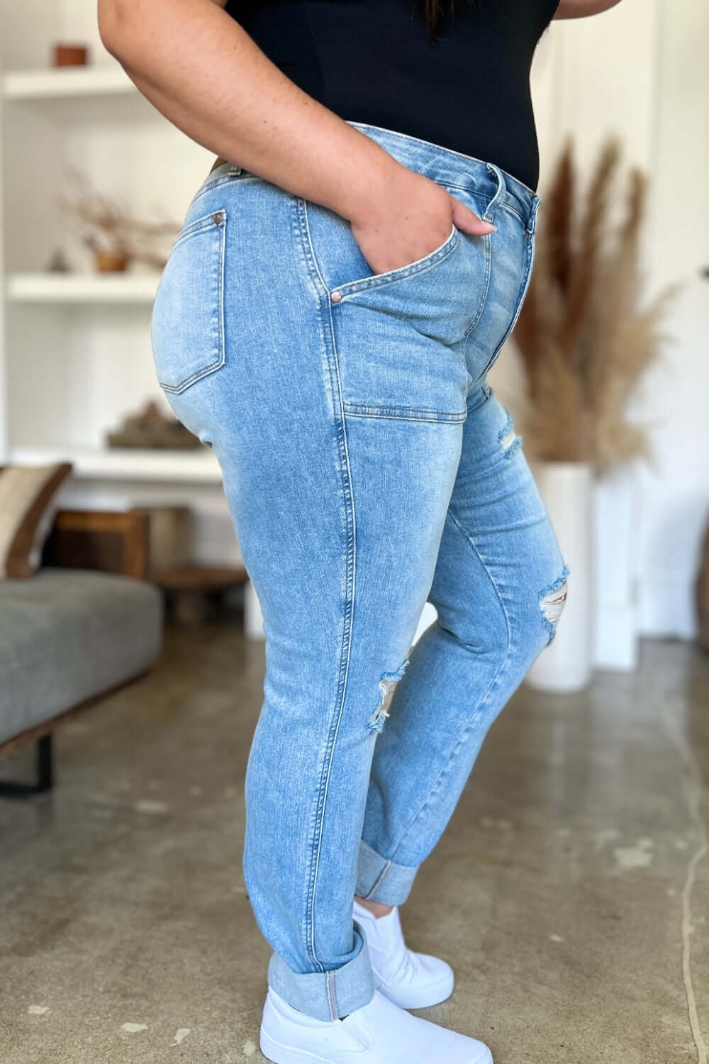 Woman modeling Judy Blue distressed straight jeans with patch pockets, showcasing a stylish and flattering silhouette.