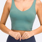 Millennia Deep V-Neck Crop Sports Bra in green, featuring a sleeveless design and flattering fit for stylish workouts.