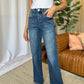 RFM Full Size High Rise Tummy Control Wide Leg Jeans on woman in white tank top standing in stylish living room