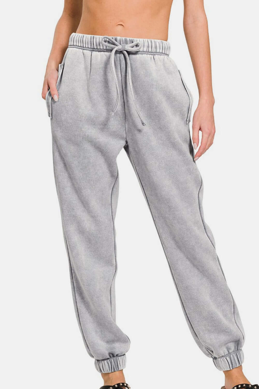 Zenana acid wash fleece sweatpants with drawstring waist and pockets, showcasing stylish comfort and edgy design.