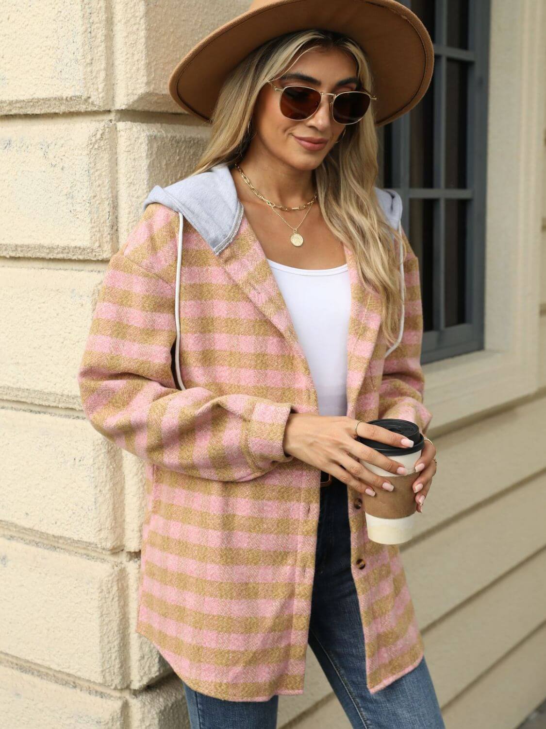 Woman wearing Bella Road Drawstring Plaid Long Sleeve Hooded Jacket in pink and beige, holding a coffee cup.