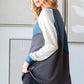 Woman wearing HOPELY color block long sleeve T-shirt with blue and gray design, showcasing casual chic fashion.