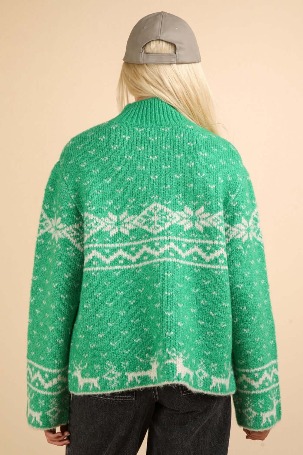 Cozy green Christmas sweater with snowflake and reindeer patterns, featuring a festive mock neck and long sleeves for holiday cheer.