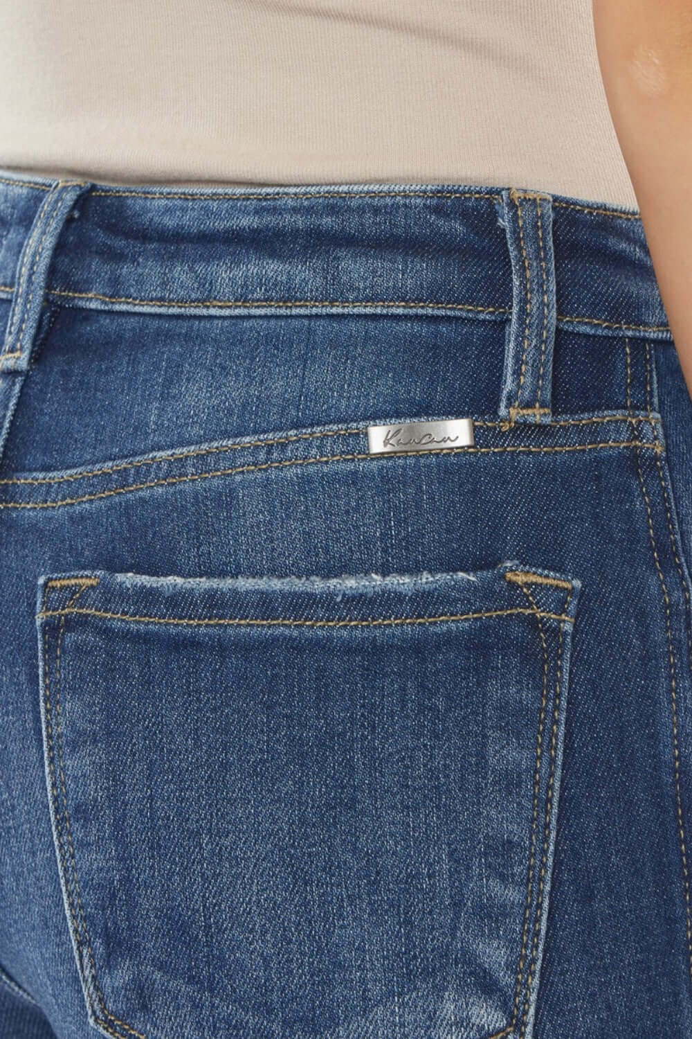 Raw Hem High Waist Cropped Jeans - back pocket close-up showing trendy raw hem details and stitching on blue denim.