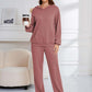 Woman in dusty pink Bella Road hoodie and pants set holding coffee, showcasing relaxed fit and cozy style.