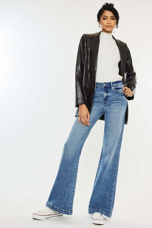 Woman wearing Kancan High Rise Wide Leg Jeans with a leather jacket and sneakers, showcasing stylish and comfortable denim fashion.