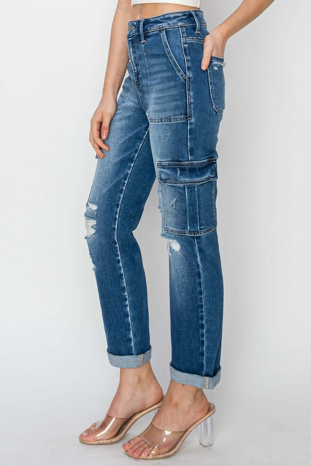 Risen high-rise cargo ankle roll-up straight jeans with cargo pockets and rolled hem, showcasing trendy and functional denim style.