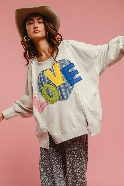 Charming model in LOVE Heart Patch Slit French Terry Sweatshirt with stylish slit and colorful patch on pink background.