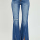 High Rise Front Slit Frayed Hem Flare Jeans by Risen Jeans with edgy front slit and retro flared silhouette for a trendy, casual look.