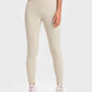 Woman in beige Millennia Highly Stretchy Wide Waistband Yoga Leggings, styled with a crop top and athletic shoes.