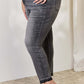 Woman wearing high waist tummy control release hem skinny jeans by Judy Blue Jeans.