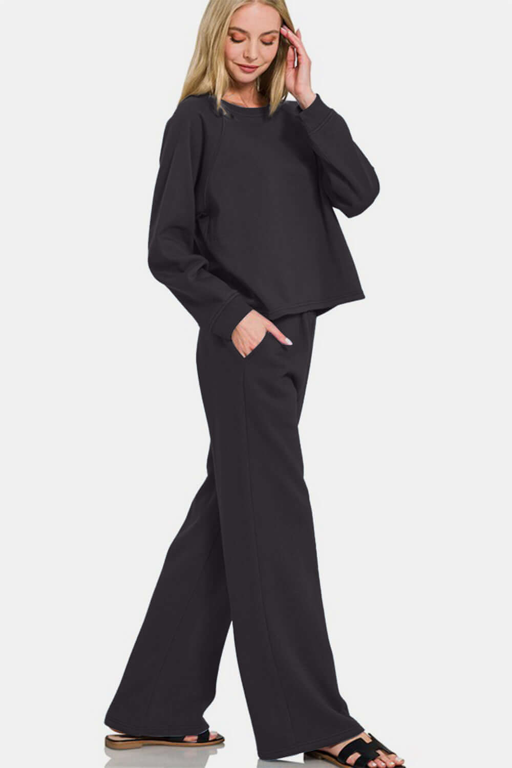 Stylish model in black round neck raglan sleeve top and elastic waist pants, perfect for casual outings and lounging.