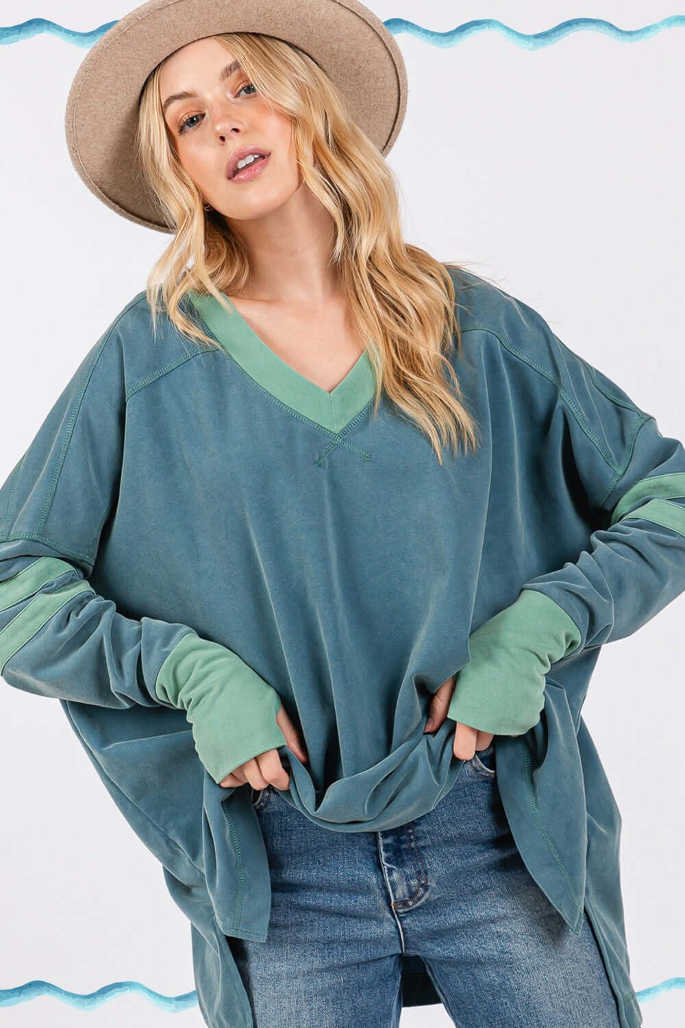 Woman wearing Mineral Wash Side Slit Contrast Top with V-neck and long sleeves, showcasing trendy and textured design elements.