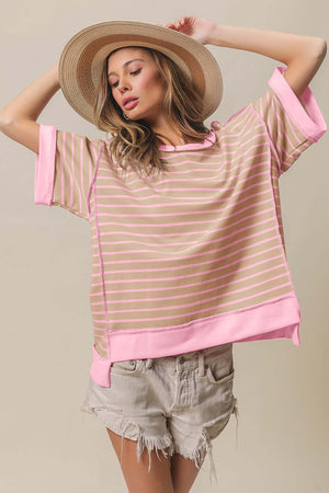 Woman wearing Exposed Seam Stripe Contrast T-Shirt with distressed shorts and a hat, showcasing urban and contemporary style