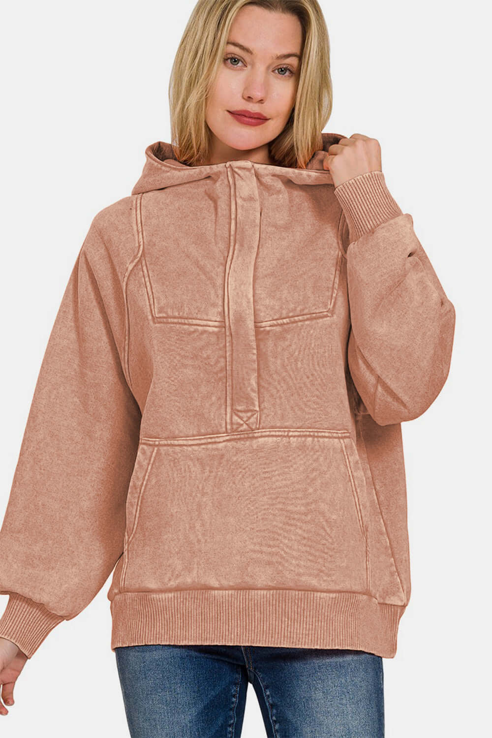 Woman wearing Zenana acid wash fleece kangaroo hoodie with kangaroo pocket and cozy hood, styled with jeans for a casual look