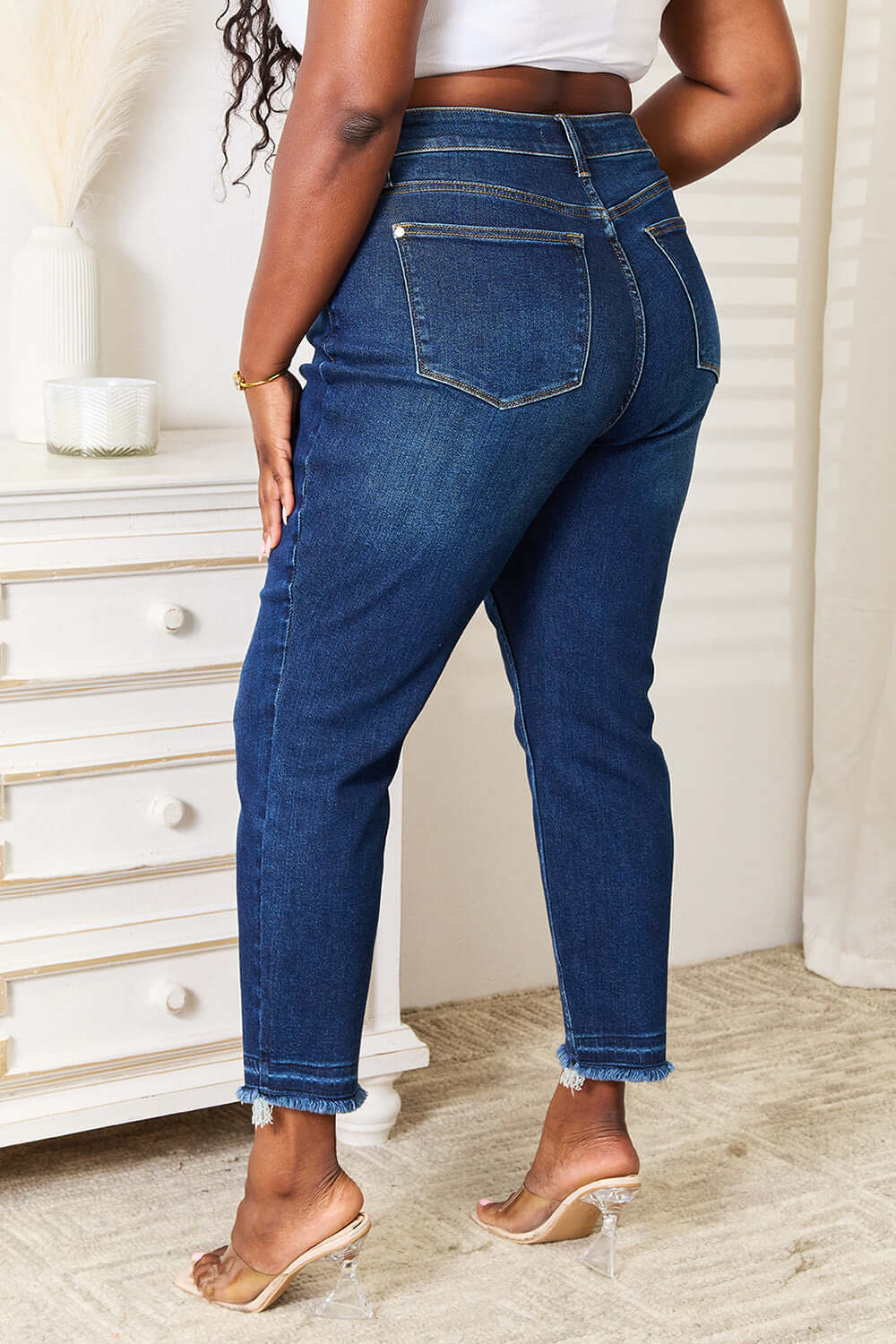 Woman wearing High Waist Released Hem Slit Jeans in deep indigo wash, Judy Blue Jeans – back view showing flattering fit and stylish design