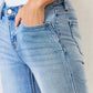 Close-up of mid rise Y2K slit bootcut jeans, showcasing a chic zip fly, side slit detail, and a classic pocketed design for a stylish look.