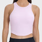 Millennia Round Neck Racerback Active Tank in soft pink, featuring a stylish crop cut and ribbed texture for a comfy workout.