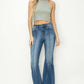 Woman wearing Risen high rise front seam detailed flare jeans with a grey sleeveless top