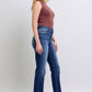 Model showcasing Judy Blue washed straight leg jeans with pockets from the side, perfect blend of style and practicality.