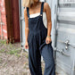 Woman wearing Bella Road Plaid Wide Leg Overalls with wide straps, standing outdoors in trendy casual style.