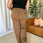 High Rise Garment Dye Wide Leg Jeans in brown, back view, showcasing high-waist fit and relaxed silhouette, styled with a black tank top.