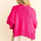 Stylish woman in a vibrant pink cardigan, showcasing the cozy drop shoulder design from the back. Perfect for layering!