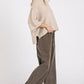 Woman wearing beige knit top and mineral wash elastic wide leg pants for a trendy and relaxed look.