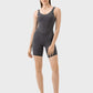 Model showcasing the Millennia Wide Strap Active Romper in grey, featuring a sleek silhouette and supportive wide straps.