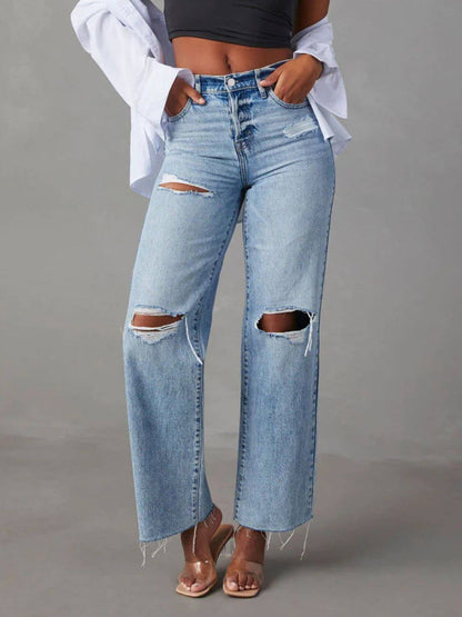 Bella Road Distressed Straight Leg Jeans with Pockets, ripped knees, buttoned closure, and no stretch, modeled with a black crop top and clear heels.